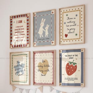 Könnte beinhalten: Eine Sammlung von sechs gerahmten Kunstdrucken mit inspirierenden Zitaten und Illustrationen. Die Drucke zeigen Kaninchen, eine Erdbeere und Texte wie "I AM" und "Love you more". Die Rahmen sind hellbraun.
