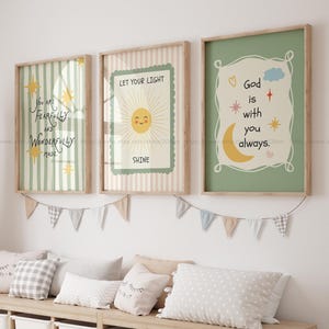 May include: Three framed art prints with inspirational quotes. The first print has green and white stripes with the text "You are fearfully and wonderfully made." The second print says "Let your light shine." The third print says "God is with you always."