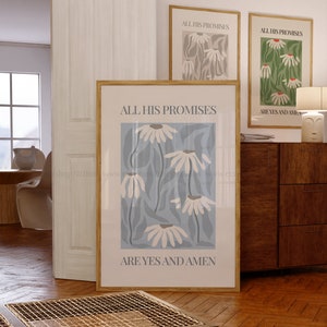 May include: A framed print with a blue background and white flowers. The print has the text "All His Promises Are Yes And Amen" in black.