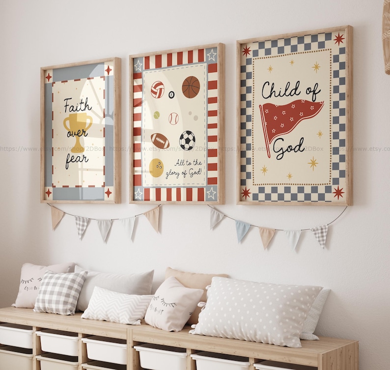 May include: Three framed art prints with inspirational quotes and sports-themed illustrations. The prints feature a trophy, various sports balls, and a flag. The color palette includes beige, red, blue, and brown, with text that reads "Faith over fear" and "Child of God."