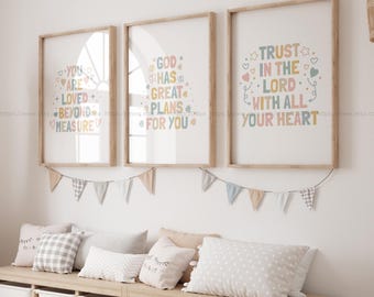 May include: Three framed prints with inspirational quotes in a light pink, blue, and green color scheme. The quotes are "You are loved beyond measure", "God has great plans for you", and "Trust in the Lord with all your heart".