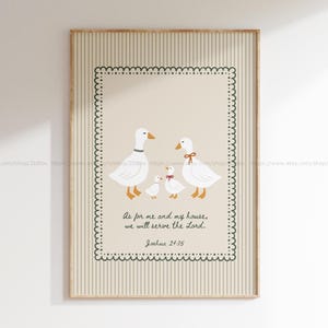 May include: A framed art print depicting a family of white geese with orange beaks and feet. The artwork includes the text "As for me and my house, we will serve the Lord. Joshua 24:15" within a decorative border. The background has vertical stripes.