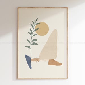 May include: Abstract art print featuring a beige figure with a cream-colored garment and a tan foot. A hand holds the garment, and a blue shape is on the left. A green plant and a yellow circle complete the design.