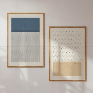 May include: Two framed abstract prints with geometric patterns. The print on the left has a blue rectangle with vertical lines. The print on the right has a white background with black dots and a tan rectangle at the bottom.