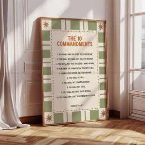 May include: A framed print featuring "The 10 Commandments" in a classic design. The text is in a serif font, set against a cream-colored background with a green and white checkered border. Decorative star accents are in each corner.