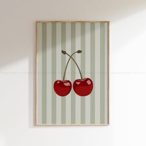 May include: Two red cherries with green stems on a green and white striped background.