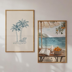 May include: Two printable art prints with a beach theme. The first print features a hand-drawn illustration of two palm trees with a beach chair and the text "He leads me beside still waters." The second print shows a watercolor painting of a beach scene with a table, a teapot, a book, and a bowl of oranges.