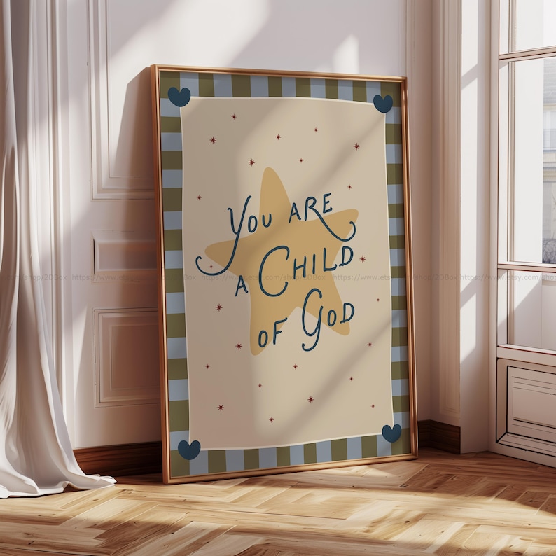 May include: Framed art print with the text "You are a Child of God" in a whimsical font. The artwork features a large yellow star and small red stars on a beige background, framed with a gold border and a blue and green checkered pattern.