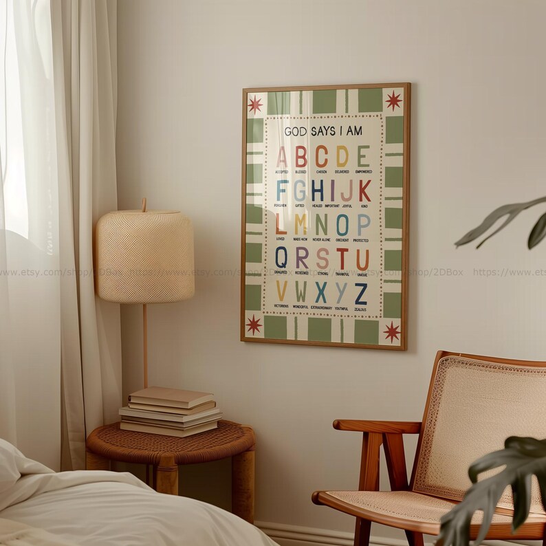 May include: A framed poster with the text "GOD SAYS I AM" and the alphabet in various colors. The poster has a green and white checkered pattern and is surrounded by a wooden frame. The poster is hanging on a white wall.