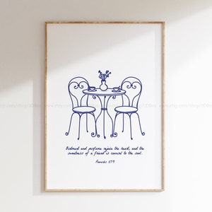 Puede incluir: Una impresión enmarcada con un dibujo lineal azul de una mesa y dos sillas, preparada para una comida. Un jarrón con flores y dos tazas están sobre la mesa. El texto dice: "El ungüento y el perfume alegran el corazón, y la dulzura de un amigo es un consejo para el alma. Proverbios 27:9."
