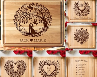 May include: Six wooden cutting boards with laser engraved Valentine's Day designs. The designs include a tree with a couple, a heart with flowers, a heart with birds, a heart with flowers and names, a heart with flowers and the words "Recipe for Love" and a list of ingredients, and a heart with flowers and the words "Happy Valentine's Day".