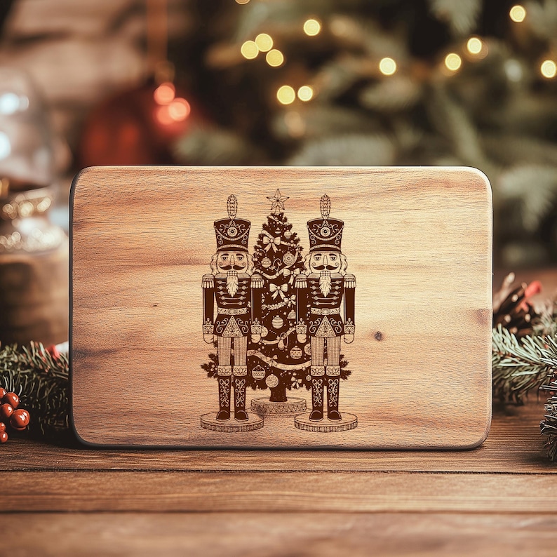 A wooden board with a decorative image of two nutcracker men standing next to a Christmas tree.