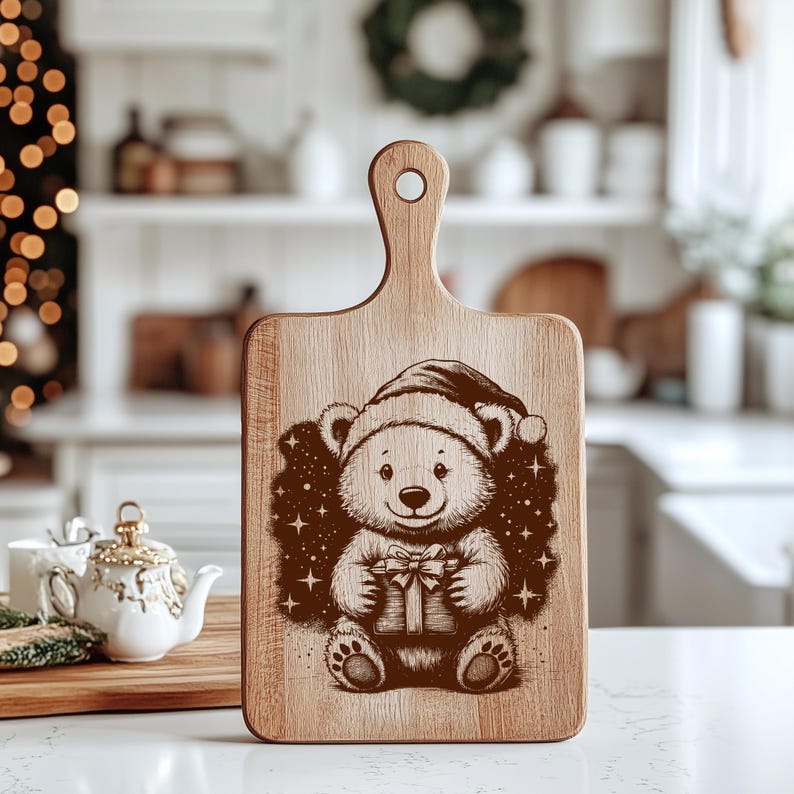 May include: Wooden cutting board with a handle, featuring a festive bear design. The bear, wearing a Santa hat, holds a gift box, surrounded by stars. The board is made of light-colored wood, perfect for holiday kitchen decor.