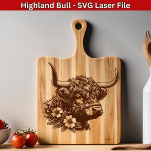 May include: A wooden cutting board with a laser-engraved design of a Highland bull's head with flowers. The bull has brown fur and large horns. The board has a natural wood grain and a handle.
