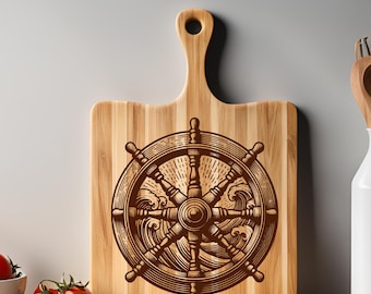 May include: A wooden cutting board with a laser-engraved design of a ship's wheel with waves. The wheel is brown and the waves are a lighter brown. The cutting board is made of light wood and has a natural grain.