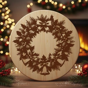May include: A round wooden serving board with a detailed brown Christmas wreath design. The wreath features pine needles, pine cones, bows, and bells. The board is set against a blurred background with Christmas lights and decorations.
