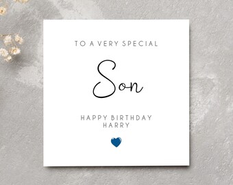 May include: A white card with the text "To a very special Son Happy Birthday Harry" and a blue heart.