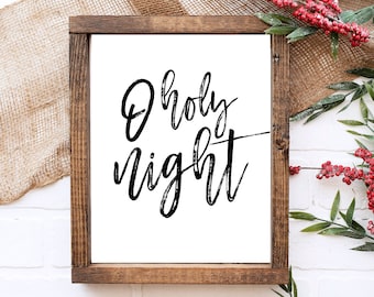 May include: A wooden framed sign with a white background and black calligraphy that reads "O holy night".