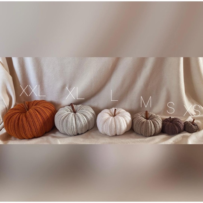 May include: Six crocheted pumpkins in various sizes, from extra large to extra small. The pumpkins are in shades of orange, beige, and brown.