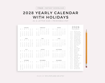 以下が含まれることがあります： A4とレターサイズ対応の、2028年版年間カレンダー。祝日入り。白黒で、右側に祝日リストがあります。画像の右側に鉛筆があります。「MADE BY MYLIFEPLANS ON ETSY」の文字が下部にあります。
