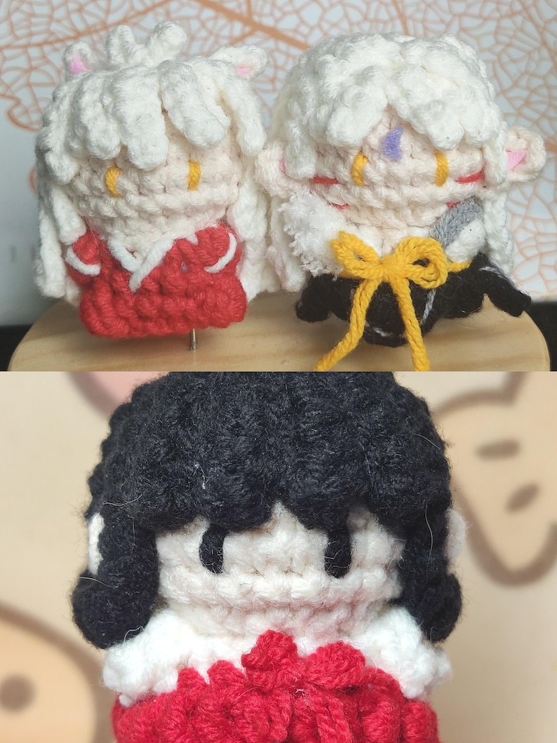 May include: Three crocheted plushies, two with white hair and red clothing, and one with black hair and red clothing. The plushies are handmade and have a cute, cartoon-like appearance.