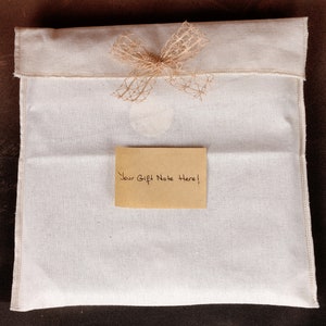 May include: A white cotton gift bag with a brown burlap bow and a brown paper gift note that says "Your Gift Note Here!"