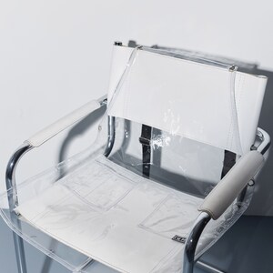 a white chair with a clear plastic seat