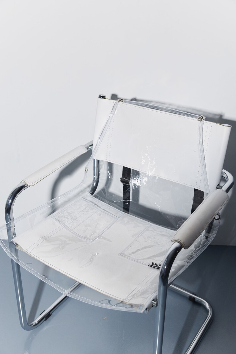 a white chair with a clear plastic seat