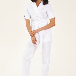 White  scrub set of lab coat and pants with belt for nurses and dentists or spa workers, cosmetology cloth for beautician