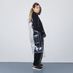 a woman standing in front of a white wall