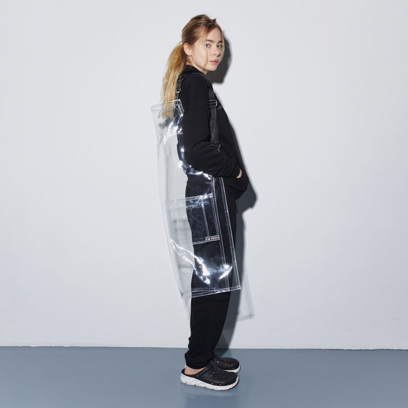 a woman standing in front of a white wall