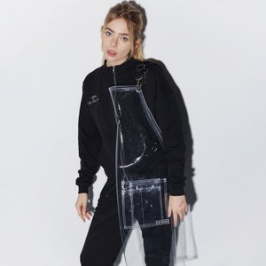a woman in a black sweatshirt and black pants