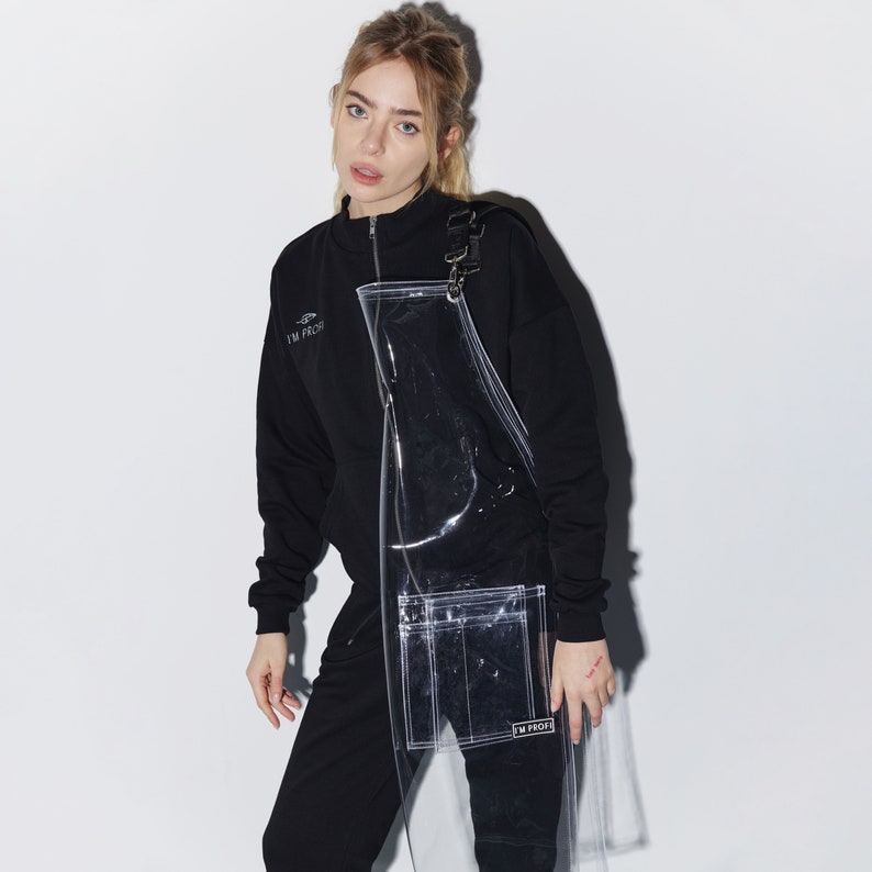 a woman in a black sweatshirt and black pants