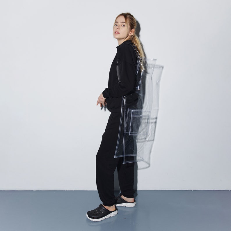 a woman standing in front of a white wall