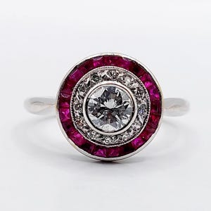 French art deco target ring 18k white gold and 0.45 carat diamond with calibrated synthetic rubies (circa 1920)