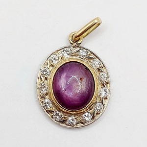 French Antique pendant 18k gold set with a 2.33 carat purple star sapphire cabochon surrounded by 0.39 carats of diamonds (circa 1900)