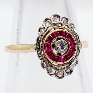 French art deco marquise ring 18k gold set with a diamond surrounded by calibrated rubies and rose cut diamonds (circa 1920) target