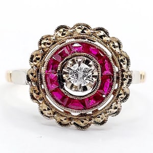 French art deco flower ring 18k gold set with a diamond surrounded by calibrated rubies in a finely crafted setting (circa 1920) target