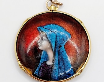 May include: A gold pendant with a round enamel portrait of a woman wearing a blue veil. The portrait is set against a red and orange background.