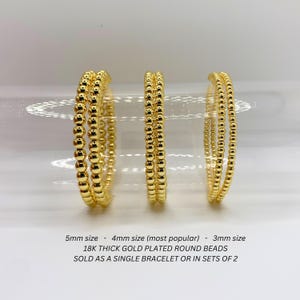 May include: Three gold-plated bead bracelets in different sizes: 5mm, 4mm (most popular), and 3mm. 18K thick gold plated round beads. Sold as a single bracelet or in sets of 2.
