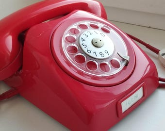 Vintage 1970s red telephone rotary Swedish by Eriksson LM in working condition.