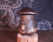 Dumpy mushroom man with pipe.