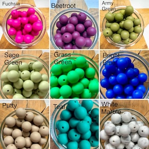 May include: A collection of nine glass bowls filled with round silicone beads in various colours including fuchsia, beetroot, army green, sage green, grass green, bright blue, putty, teal, and white marble, each labelled with its colour name.