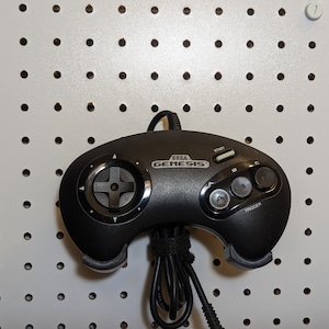 Sega Genesis 3-button controller display mount for standard pegboard