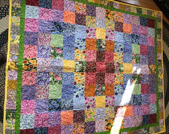 Lovely and bright floral quilt. Lap size for all ages.