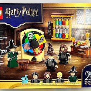 May include: LEGO Harry Potter Hogwarts Castle Sorting Hat Ceremony building toy set box featuring 124 pieces, a spinning house wheel, an hourglass display, and minifigures of Harry Potter, Hermione Granger, Draco Malfoy, and Professor McGonagall.