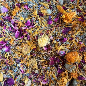 close up of botanical ingredients including uva ursi, calendula, lavender, rose, and yarrow, this herbal bath tea blend smells amazing and is designed to soothe. This herb and salt blend relaxes muscles and can help reduce swelling and pain.