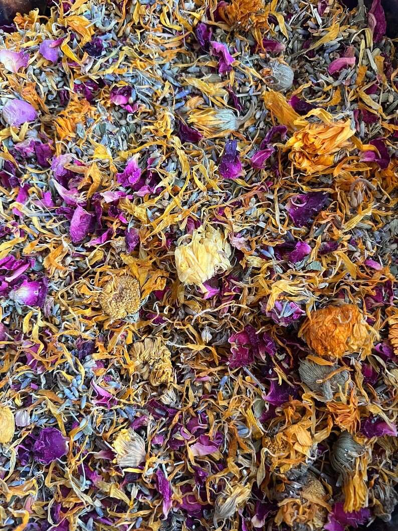close up of botanical ingredients including uva ursi, calendula, lavender, rose, and yarrow, this herbal bath tea blend smells amazing and is designed to soothe. This herb and salt blend relaxes muscles and can help reduce swelling and pain.