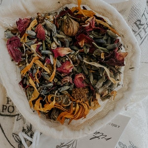 close up of botanical ingredients including uva ursi, calendula, lavender, rose, and yarrow, this herbal bath tea blend smells amazing and is designed to soothe. This herb and salt blend relaxes muscles and can help reduce swelling and pain.