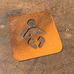 May include: A rusty orange metal sign with a cutout of a baby in a nappy. The sign is square shaped and has rounded corners.